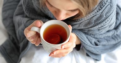 Sick woman drinking tea.