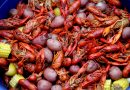 Close up of crawfish, potatoes, corn cobs and sausages from a crawfish boil.