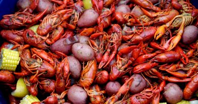 Close up of crawfish, potatoes, corn cobs and sausages from a crawfish boil.