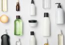 Top view of different cosmetic bottles and container on white background