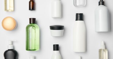 Top view of different cosmetic bottles and container on white background