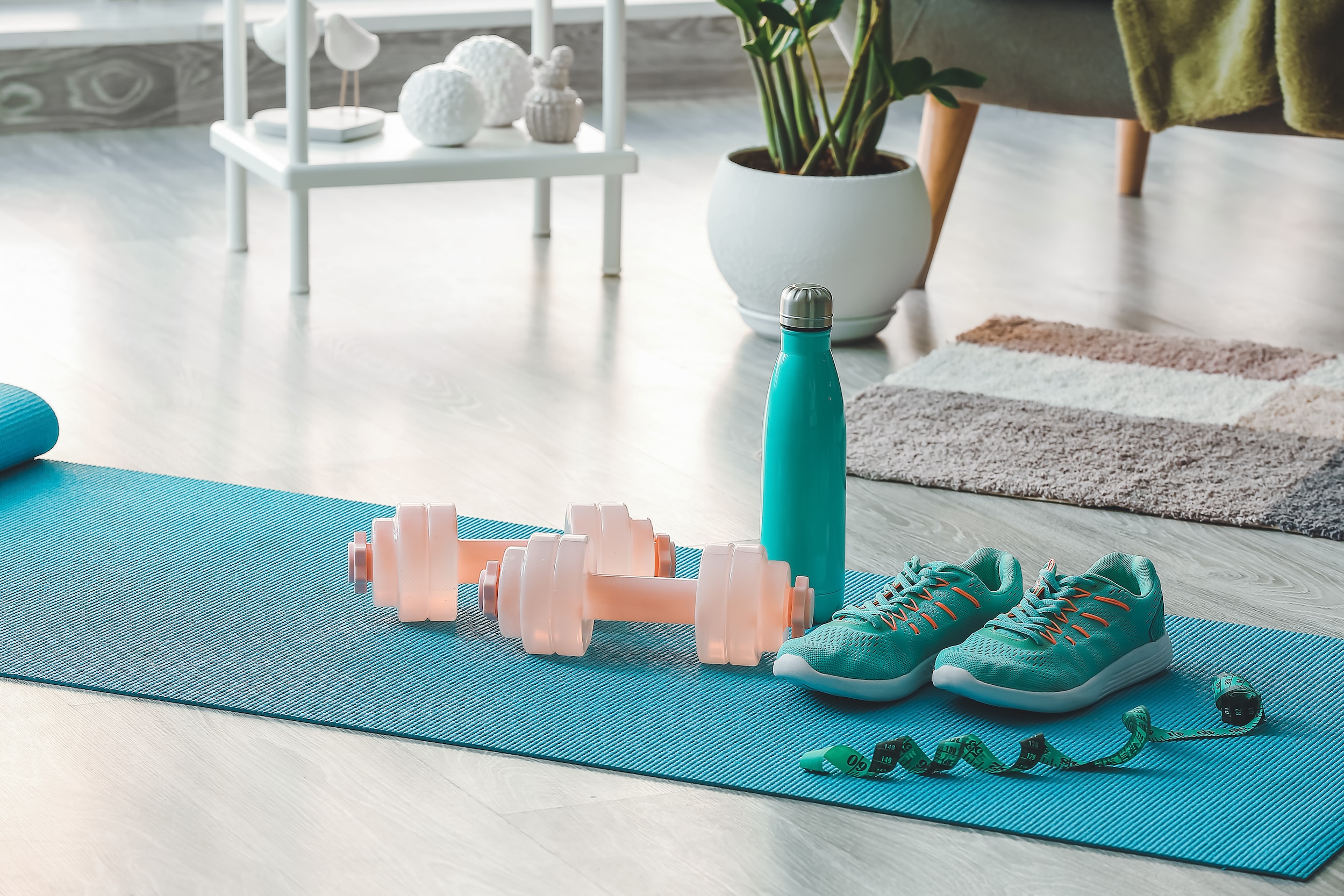 Sports equipment on yoga mat at home