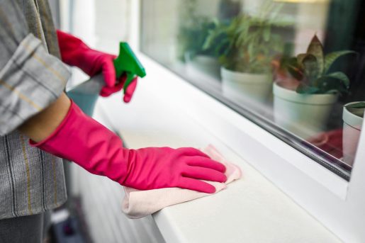 Person cleaning wearing gloves.