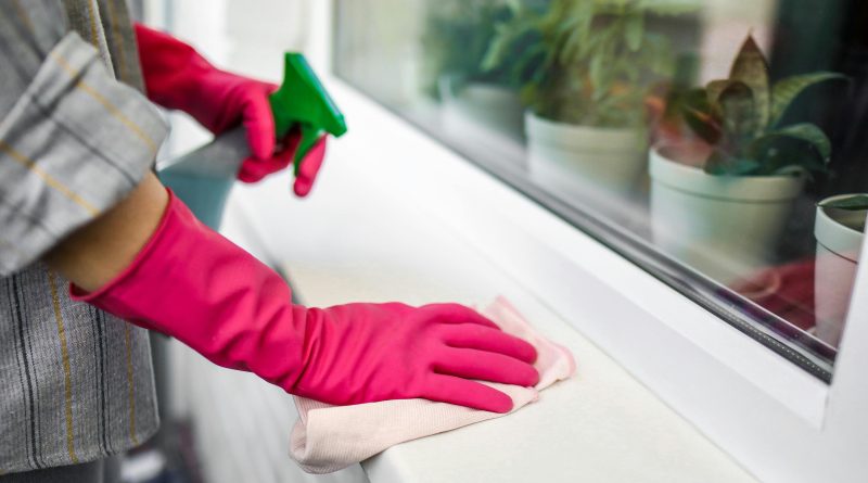 Person cleaning wearing gloves.
