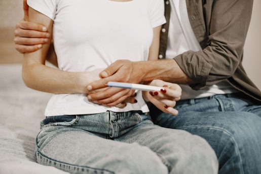 Couple holding a pregnancy test.