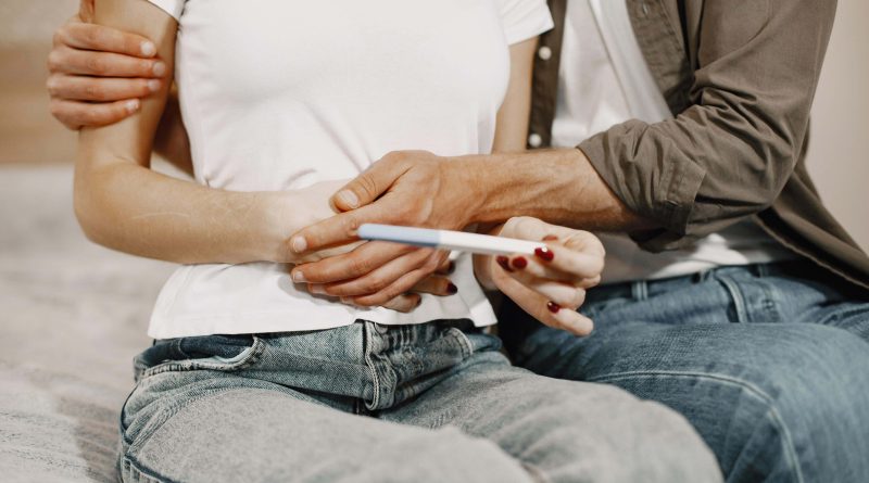 Couple holding a pregnancy test.