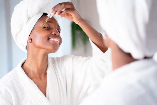 Woman applying skincare.