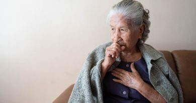 Asian senior ill female have a cough and sore throat. Causes of cough include common cold, flu, respiratory tract infection, pneumonia, bronchitis, allergy or asthma. Elderly health care concept.