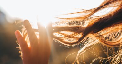 Woman touches the lock of hair. Selective focus
