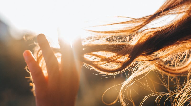 Woman touches the lock of hair. Selective focus
