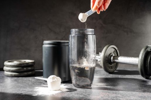 Creatine powder in a measuring scoop.