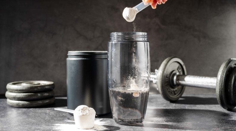Creatine powder in a measuring scoop.