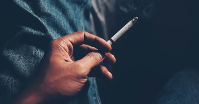 Hand holding a cigarette.