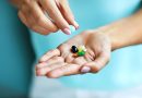 Hand holding vitamins.