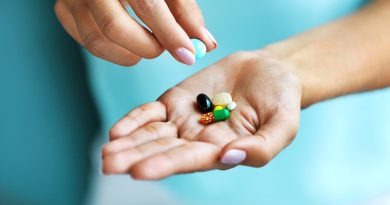 Hand holding vitamins.