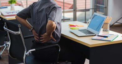 Sitting at desk with back pain.