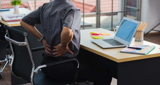 Sitting at desk with back pain.