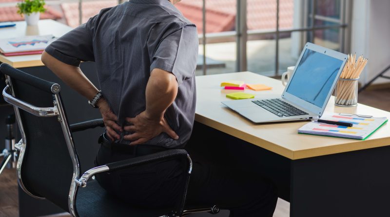 Sitting at desk with back pain.