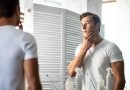Young man looking in the mirror.