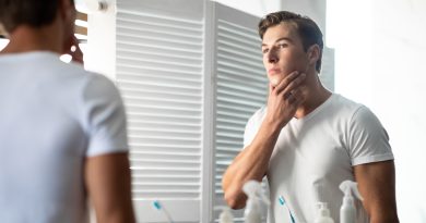 Young man looking in the mirror.