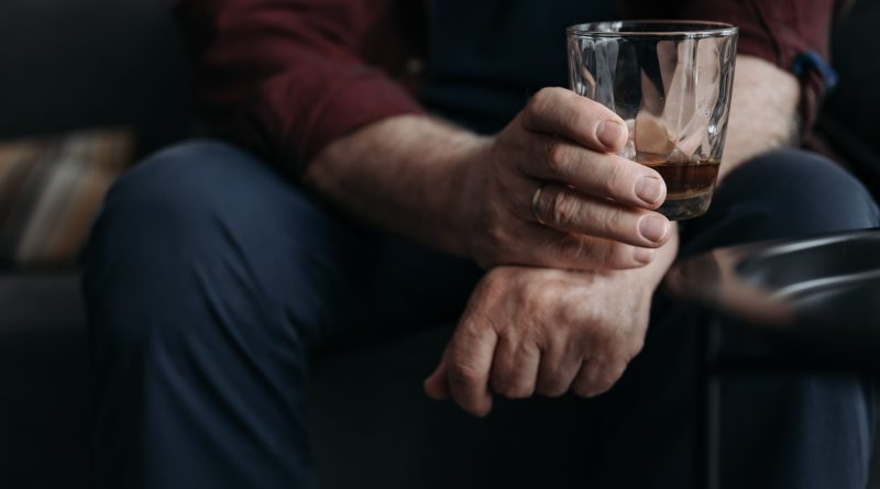 Hand holding a drink.