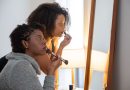 Two women doing makeup.