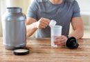 Man with protein shake bottle and jar.