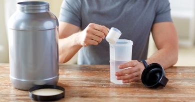Man with protein shake bottle and jar.