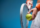 Person holding tennis racket and ball.