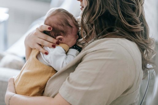 Woman holding baby.