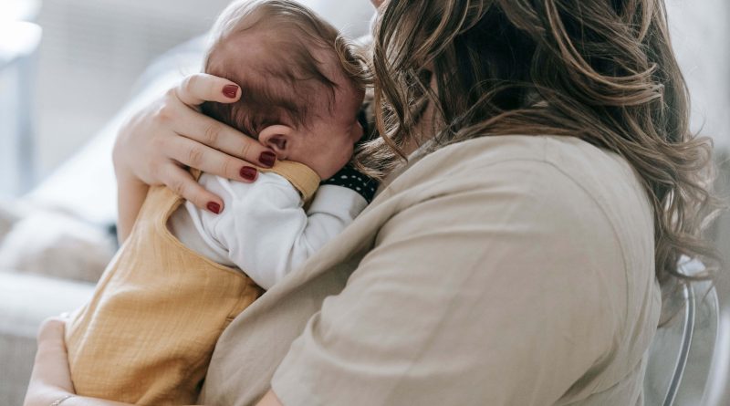 Woman holding baby.
